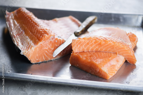 Fillet of salmon fish on metal plate closeup. Food photography