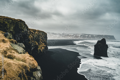 Sunrise at famous Black Sand Beach Reynisfjara in Iceland. Windy Morning. Ocean Waves. Colorful Sky. Morning Sunset.