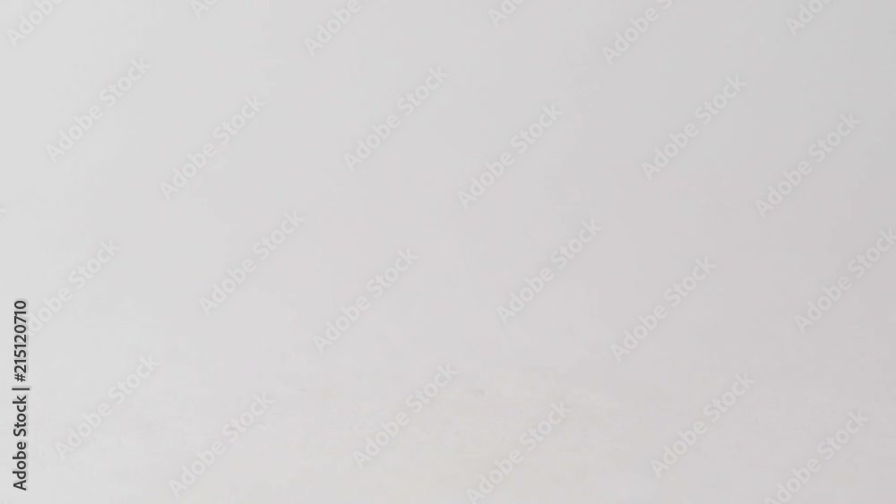 Black olives fall under the spray of water on a mirror surface in slow motion Black olives fall under the spray of water on a mirror surface in slow motion