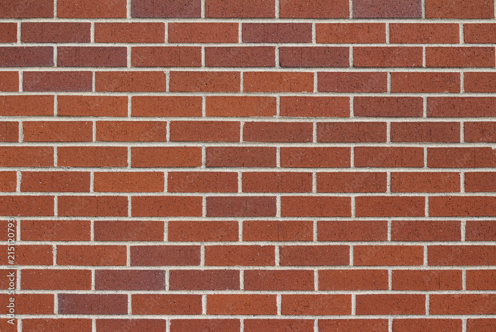 Reddish brown brick wall background in traditional running bond pattern Reddish brown brick wall background in traditional running bond pattern