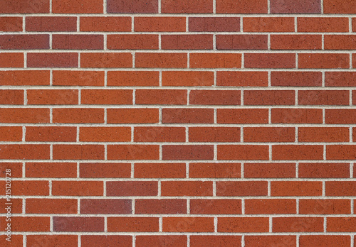 Reddish brown brick wall background in traditional running bond pattern