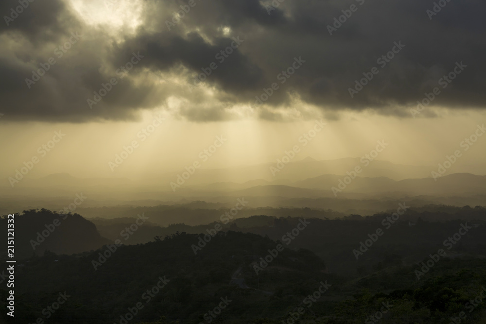 Beautiful and dramatic sunset with sun beams hitting a mountainn range in Panama