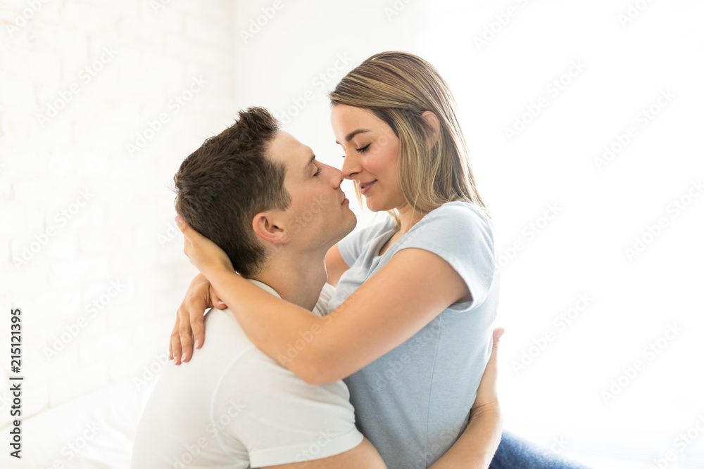 Passionate Couple About To Kiss In Brightly Lit Bedroom Passionate Couple About To Kiss In Brightly Lit Bedroom