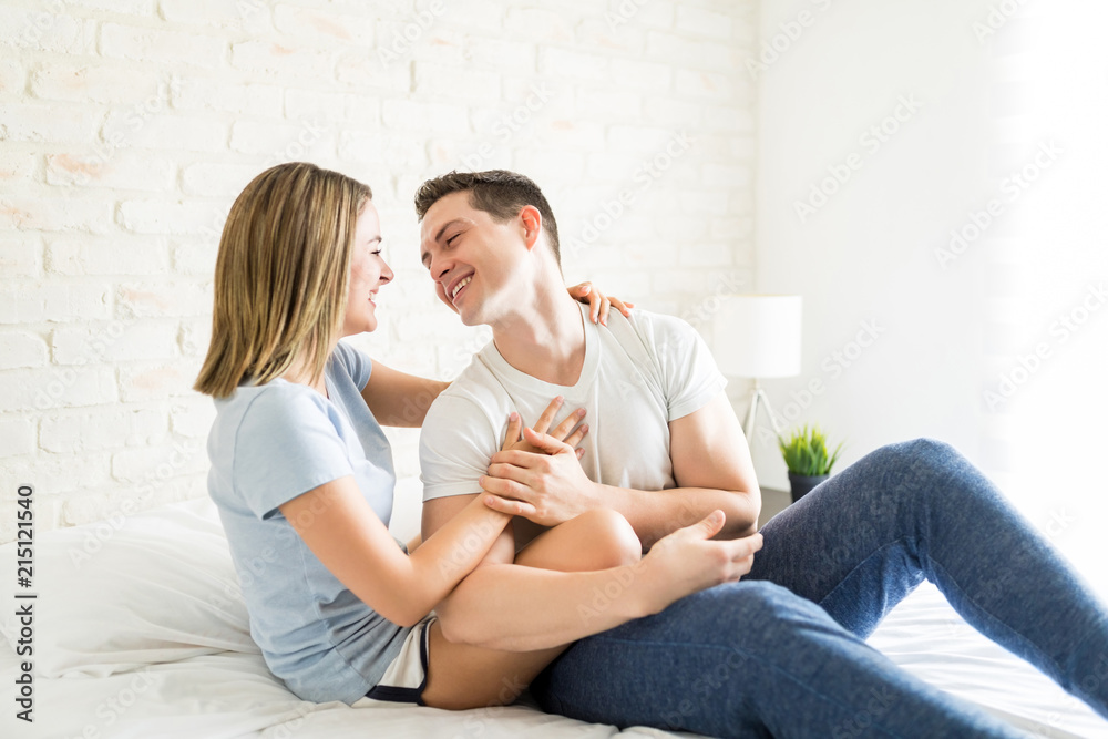 Man Flirting With Woman In Bed At Home