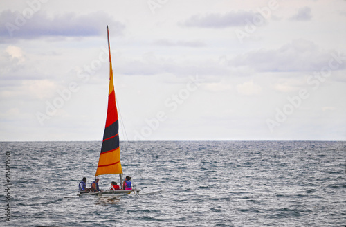 Four people sailing in a small boat off the Pacific coast of Panama