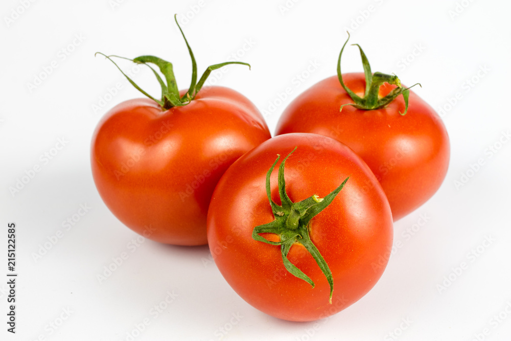 Red tomatoes on a white table. Tasty vegetables for the best dishes in the kitchen. Red tomatoes on a white table. Tasty vegetables for the best dishes in the kitchen.