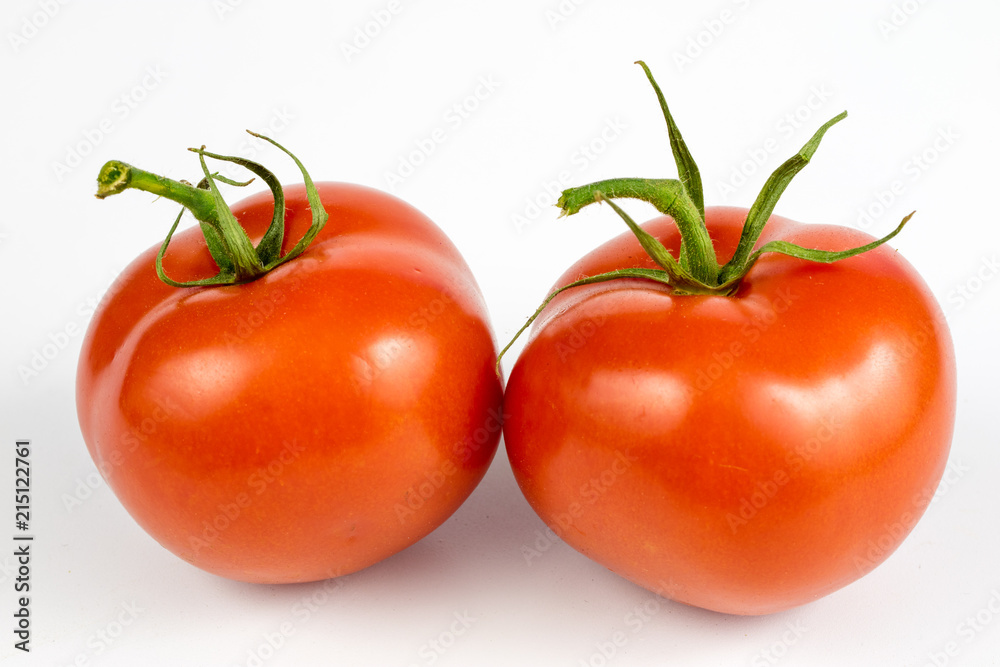 Red tomatoes on a white table. Tasty vegetables for the best dishes in the kitchen. Red tomatoes on a white table. Tasty vegetables for the best dishes in the kitchen.