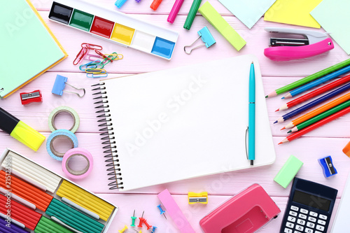 School supplies with blank sheet of paper on wooden table