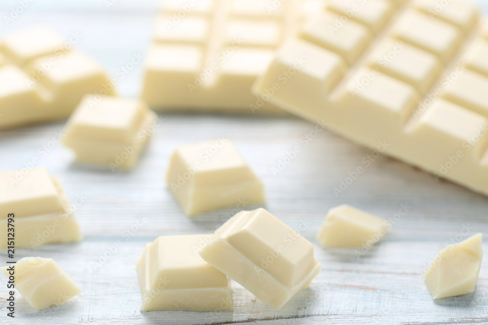 White chocolate pieces on wooden table White chocolate pieces on wooden table