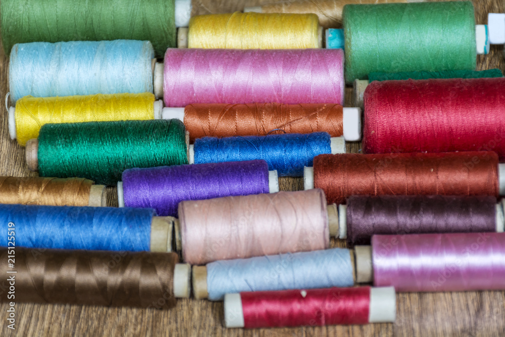Multi Colored Thread Yarns on Wooden Background Multi Colored Thread Yarns on Wooden Background