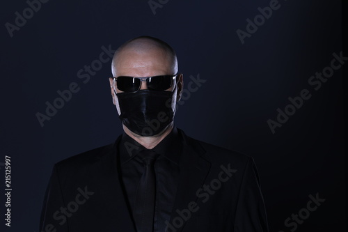 a man in a black mask on a black background
