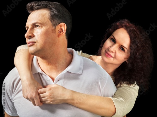 Portrait of Wife Embracing Husband who is Looking Sideways