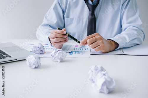 Senior businessman depressed and exhausted, businessman at his desk frustrated with problems with a pile of work and holding pen while sitting on office, Feeling sick and tired