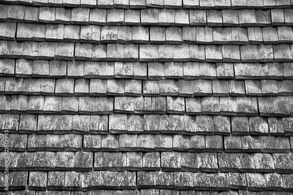 Old traditional worn wooden tiled roof background.  Sepia photo.