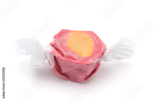 Single Piece of Red and Orange Salt Water Taffy on a White Background
