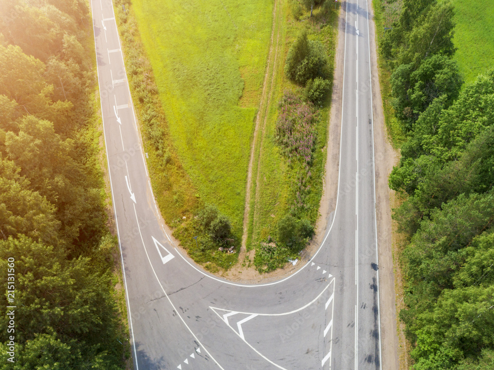 Aerial view of highway. Aerial view of a country road. Car passing by. Aerial road. Aerial view flying. Captured from above with a drone.