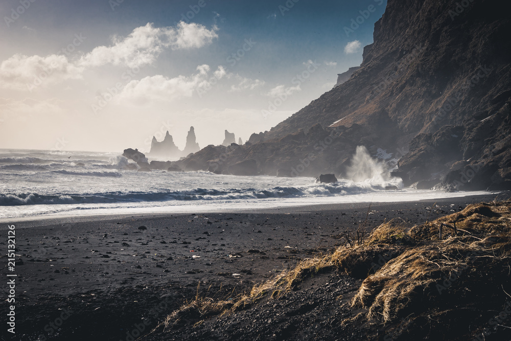 Sunrise at famous Black Sand Beach Reynisfjara in Iceland. Windy Morning. Ocean Waves. Colorful Sky. Morning Sunset.