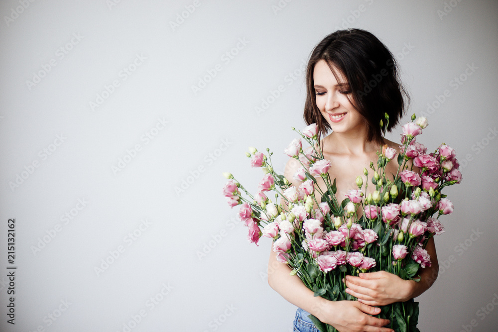 Beautiful girl with a bouquet flowers.