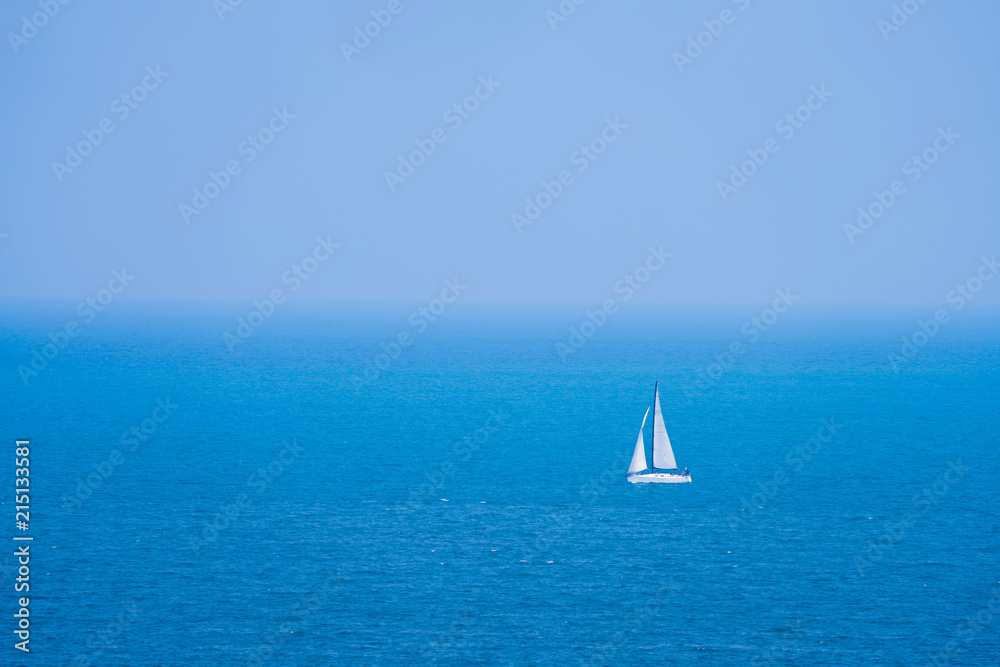 white sailboat in blue sea