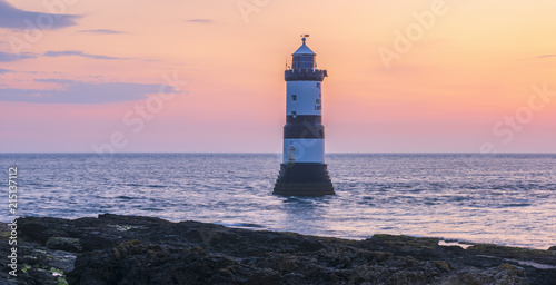 UK, Wales, Anglesey, Penmon, Black Point, Trwyn Du Lighthouse (Penmon Lighthouse) at sunrise photo