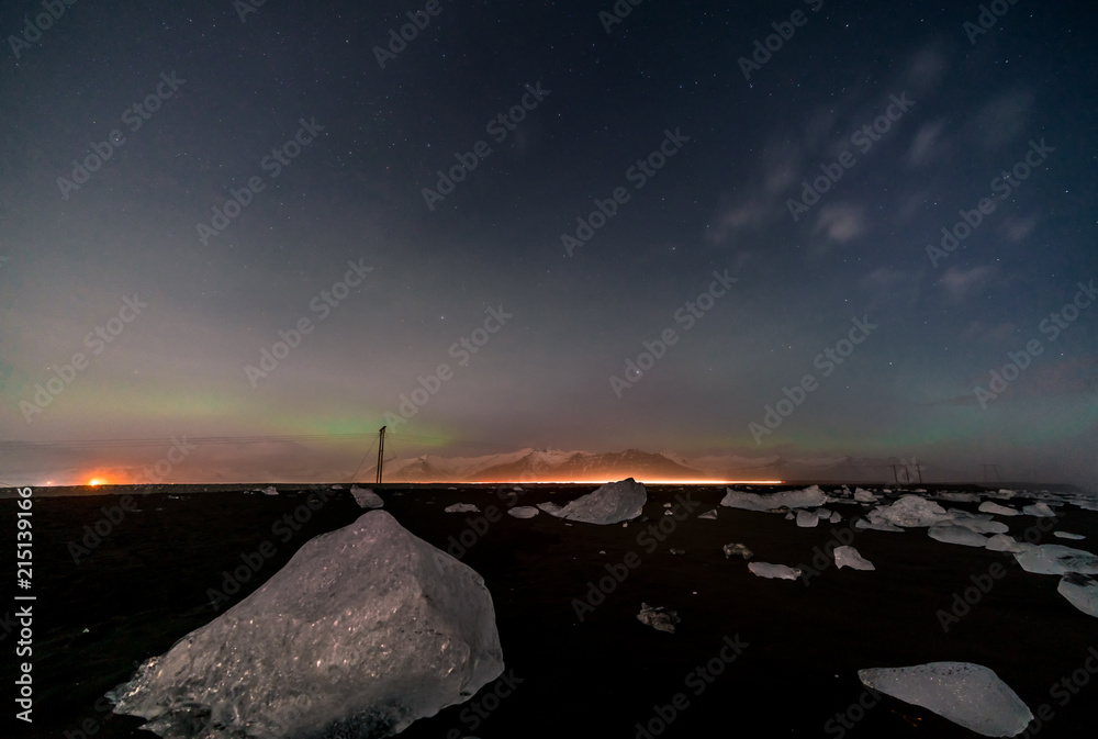 Northern lights on the Diamond beach in south east Iceland, Jokursarlon Vik ice rocks ocean