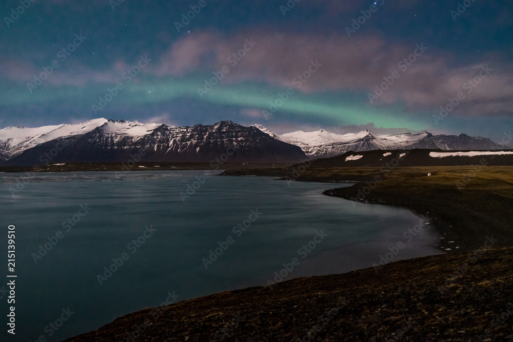 Northern lights on the Diamond beach in south east Iceland, Jokursarlon Vik ice rocks ocean