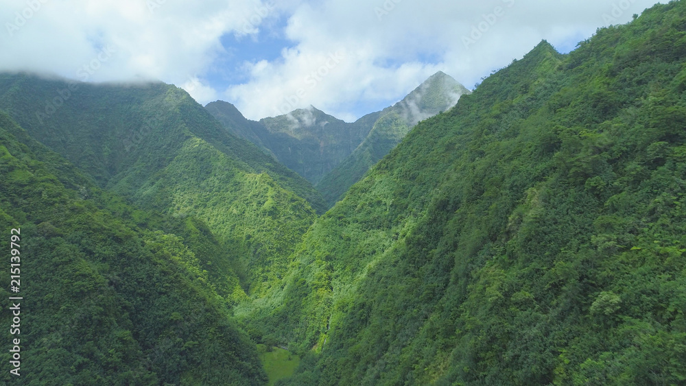 AERIAL: Breathtaking aerial view of the mountains towering over empty valley. AERIAL: Breathtaking aerial view of the mountains towering over empty valley.