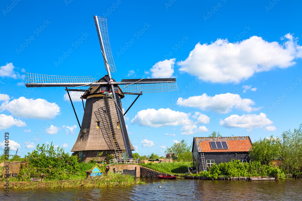 Famous windmills in Kinderdijk village in Holland. Colorful spring rural landscape in Netherlands, Europe. UNESCO World Heritage and famous tourist site.