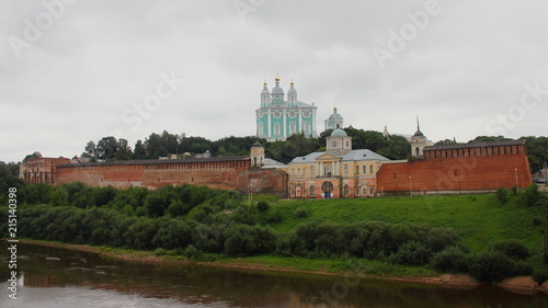 Russia -  the Smolensk fortress wall and the Church of Hodegetria on the background of the Uspensky Cathedral in the summer cloudy day