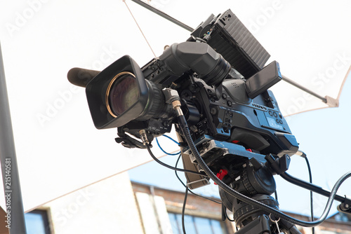Professional broadcast video camera with teleoptics on a tripod