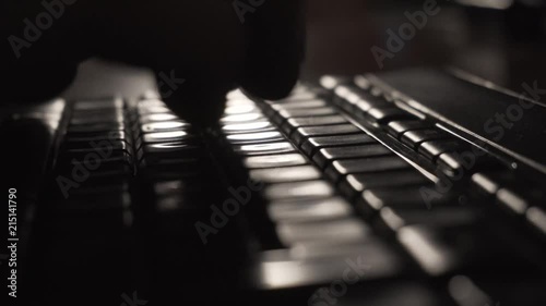 Fingers typing on the keyboard in the dark 4K