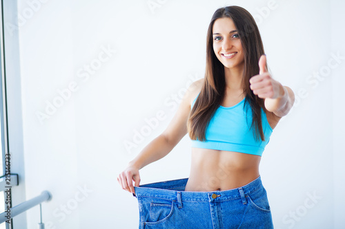 Diet. Dieting concept. Woman in Sportswear Measuring Her Waist © Maksymiv Iurii
