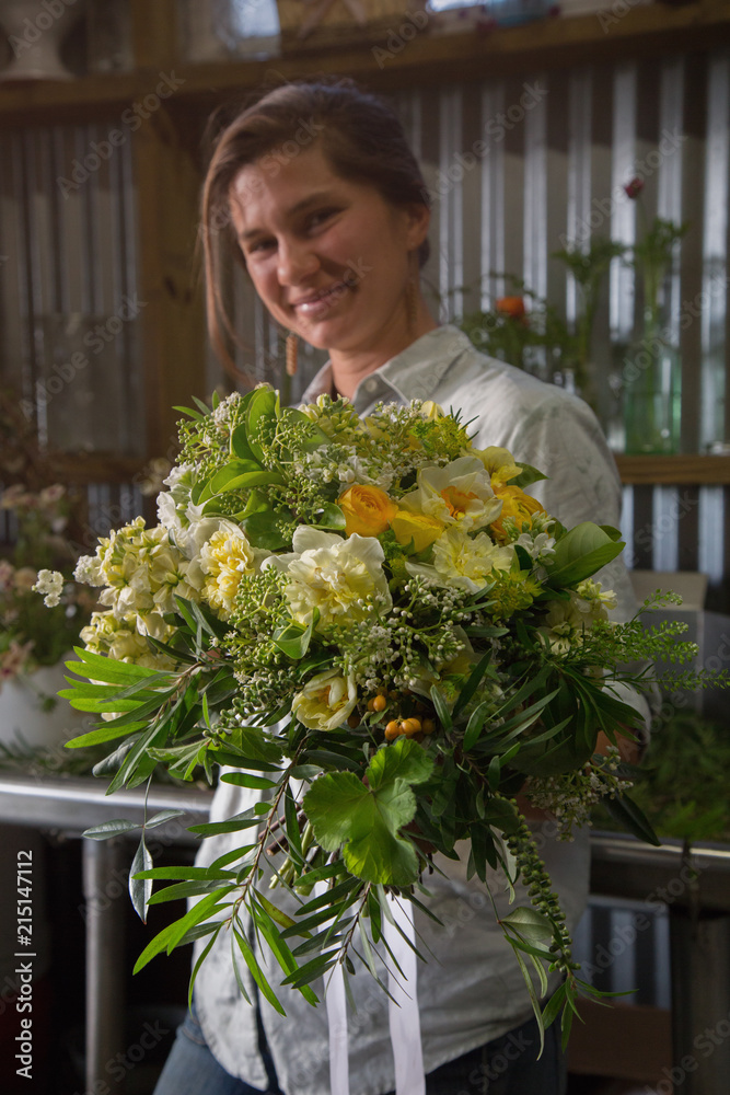 A flower farmer designs and displays a bouquet from flowers she has grown A flower farmer designs and displays a bouquet from flowers she has grown