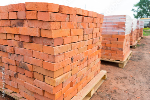 The bricks are stacked on wooden pallets and prepared for sale. Clay brick is an ecological building material.