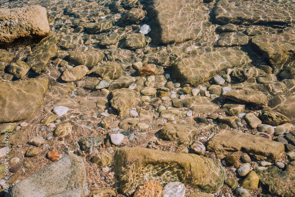Coast. Pebble beach. Background for travel agencies. Holidays in hot countries. Sand, stones and the sea. Side, Turkey. Coast. Pebble beach. Background for travel agencies. Holidays in hot countries. Sand, stones and the sea. Side, Turkey.