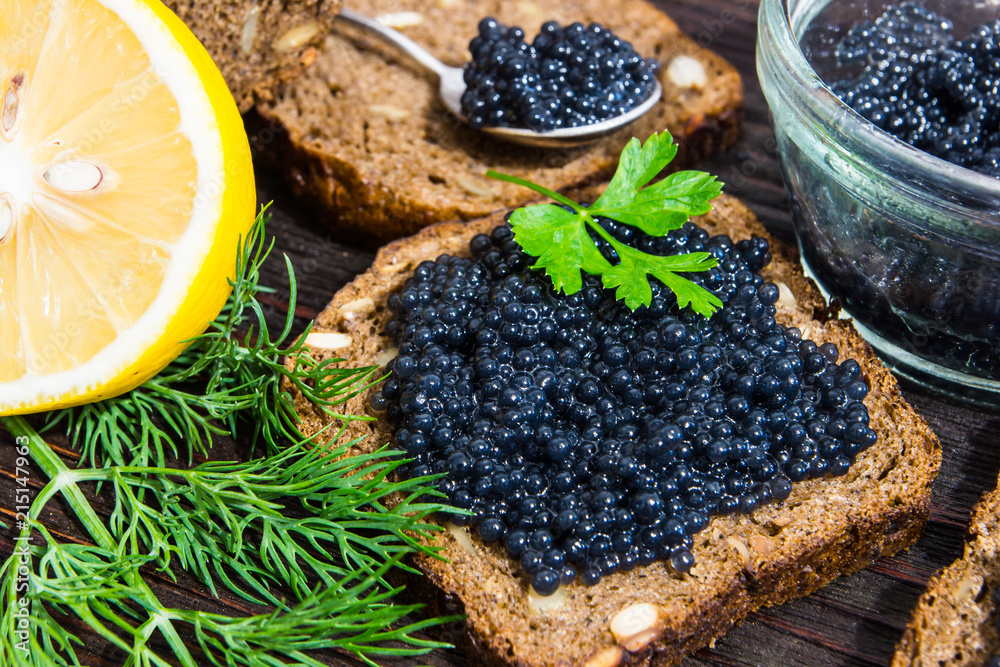 Black caviar on a sandwich. Put a silver spoon on the sandwich. Black caviar on a sandwich. Put a silver spoon on the sandwich.