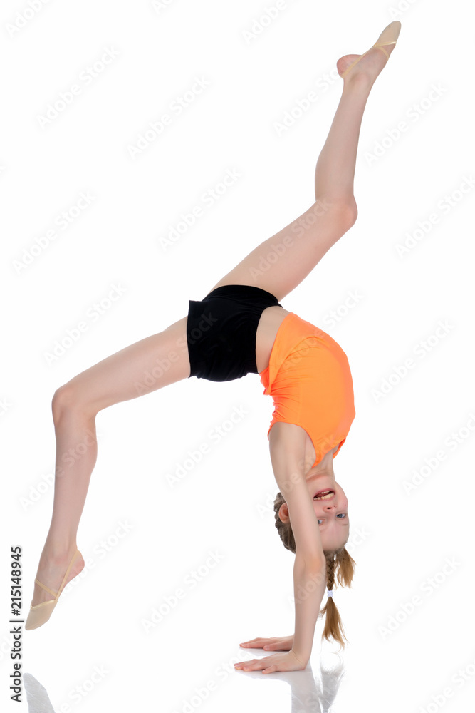 The gymnast performs a handstand with bent legs. The gymnast performs a handstand with bent legs.