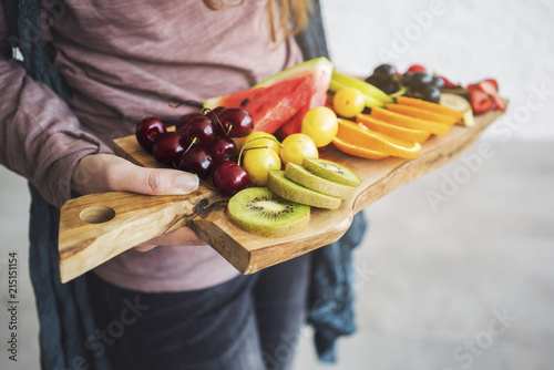 Female hands holding assorted fruits