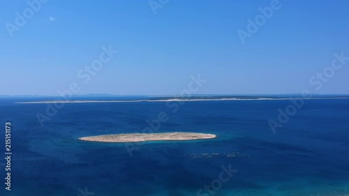Lonely island surrounded by a very blue sea