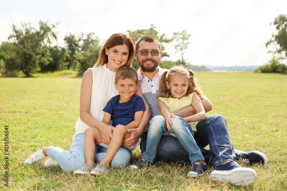 Happy family spending time together with their children outdoors