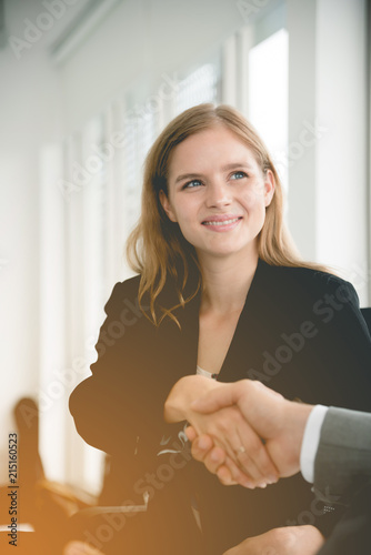 businesswoman shaking hands with business deals