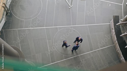 Three business people handshaking outdoors. View from the top. Close-up.