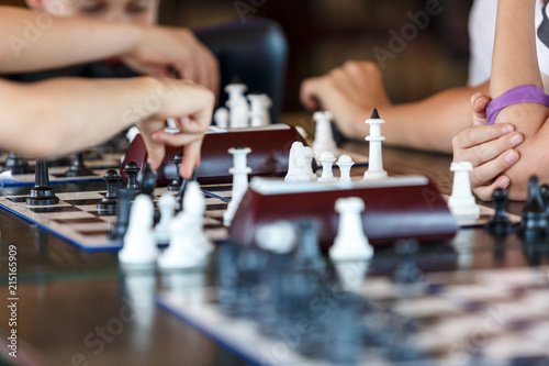 smart, cute, young boy is making a move on the chessboard. Education concept, intellectual game, training, tournament
