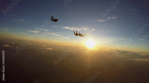 Skydivers having fun at the amazing sunset 4K video