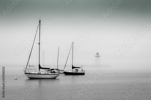 Foggy boats with lighthouse