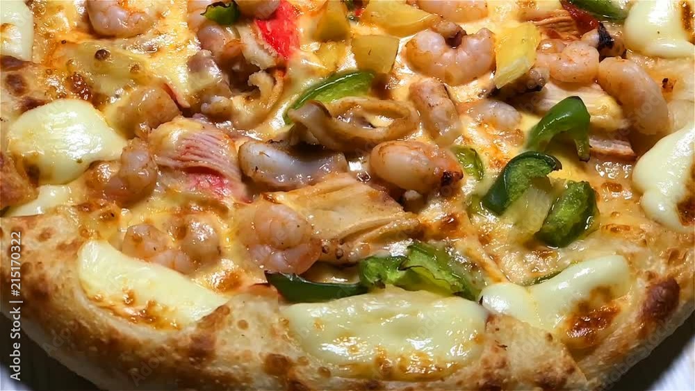Rotated whole seafood pizaa closeup Rotated whole seafood pizaa closeup