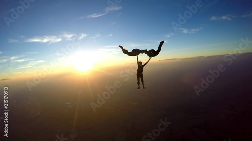 Skydivers having fun at the amazing sunset 4K video