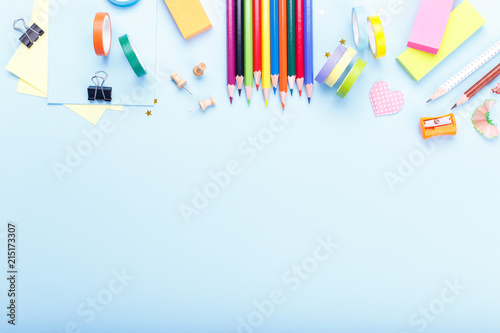 Colorful stationary school supplies on blue trending background, space or text flat lay