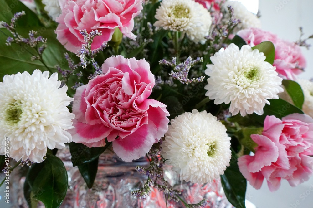 The bouquet of pink carnation and white chrysanthemum, Beautiful fresh blossoming flower as a background, Wedding décor, Side view The bouquet of pink carnation and white chrysanthemum, Beautiful fresh blossoming flower as a background, Wedding décor, Side view