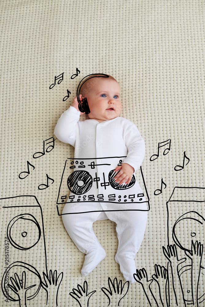 Cute DJ baby girl wearing headphones playing music at mixer - obrazy, fototapety, plakaty 
